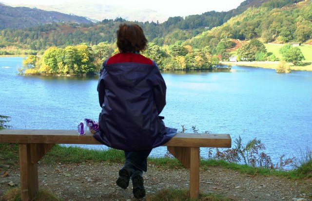 The Quirky Traveller on bench at Rydal Water in the Lake District, Cumbria